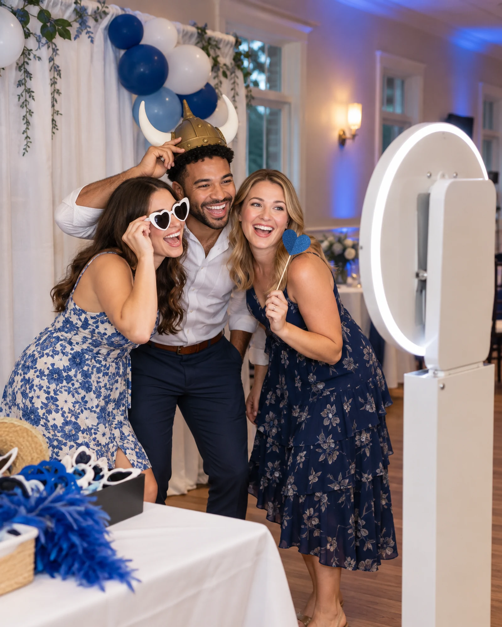 Friends using an open-air photo booth at a local celebration